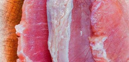 Pieces of sliced pork on a wooden cutting board photo