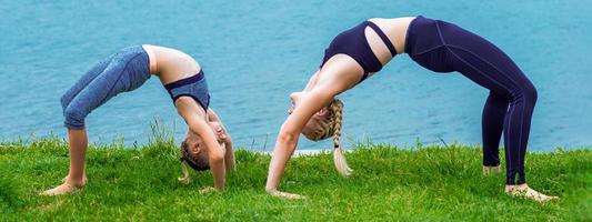 Mother and daughter doing exercise at the shore photo