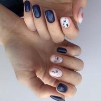 Stylish trendy female blue manicure with design.Hands of a woman with blue manicure on nails photo