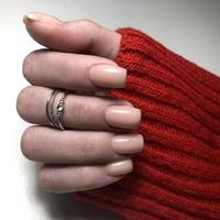 Stylish trendy female pink manicure.Hands of a woman with pink manicure on nails photo