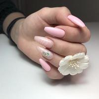 Women's pink manicure with design.Hands of a woman with pink manicure on nails photo