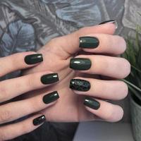 Stylish trendy female green manicure with design.Hands of a woman with green manicure on nails photo