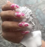 Stylish trendy female white manicure with design.Hands of a woman with white manicure on nails photo