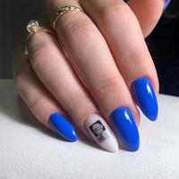 Stylish trendy blue female manicure.Hands of a woman with blue manicure on nails photo