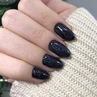 Stylish trendy black female manicure.Hands of a woman with black manicure on nails photo