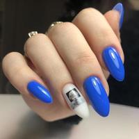 Stylish trendy blue female manicure.Hands of a woman with blue manicure on nails photo