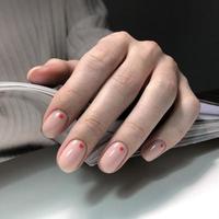 Women's pink manicure with design.Hands of a woman with pink manicure on nails photo