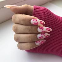 Stylish trendy female white manicure with design.Hands of a woman with white manicure on nails photo