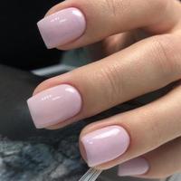 Stylish trendy female pink manicure.Hands of a woman with pink manicure on nails photo