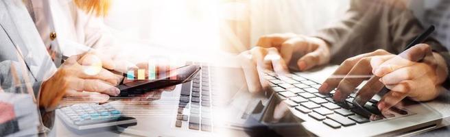 Businessman hands working with finances about cost and calculator and laptop with tablet, smartphone at office in morning light photo