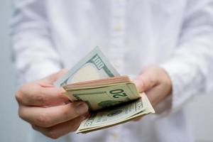 Businessman counting hundred dollar bills. Money and trade concept. Close up photo