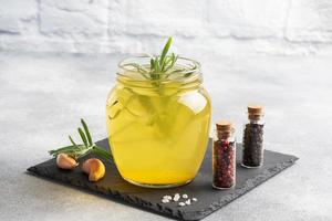 Homemade beef bone and vegetable broth with turmeric seasoning in a glass jar for storage and carrying. Healthy food with collagen and amino acids. Copy space. photo