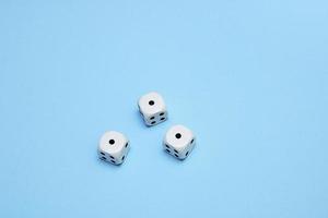 three dice with the same dropped out numbers lie on a blue background photo