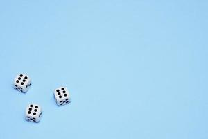 three dice with the same dropped out numbers lie on a blue background photo