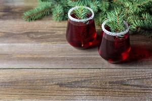 Cranberry red drink decorated with fir tree branches berry and sugar. Christmas hot mulled wine photo