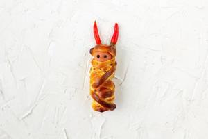 Scary sausage mummies in dough for kids party. Funny crazy Halloween food for children. photo