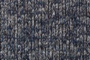 macro photo of warm gray melange polyester sweater with even vertical structure