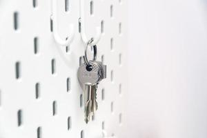 photo of keys hanging on a white hook in the hallway