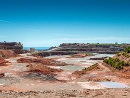 panoramic view of an old abandoned quarry on a sunny day photo