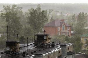 russian suburbs roofs under heavy rain telephoto shot photo