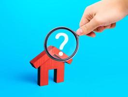 Realtor examines houses through a magnifying glass. Real estate market review. Quality of housing and availability of infrastructure. Verification of declared compliance. Price, location, legality photo