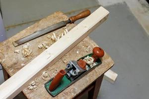 planer, file and wooden block on a stool photo