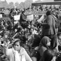 Delhi, India December 25 2021 - Delhi Contractual Guest Teachers with posters, flags and graffitis protesting against Delhi AAP Government for making policy, Delhi Teacher protesting Black and White photo