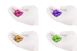 set of hand in medical glove holding colored organic med capsules isolated on white background closeup photo