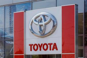 Toyota logo on car dealership building at sunny day - Toyota Motor Corporation is a Japanese automotive manufacturer.