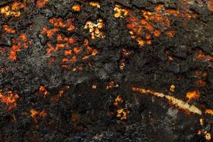 Bottom side of a cast iron pan with thicl layer of soot on it. photo