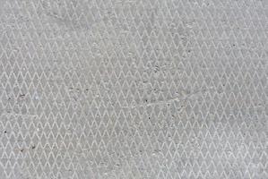 seamless old flat concrete texture with diamond pattern and signs of light erosion photo