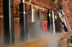 Electronic cigarette on a background of vape shop. E-cigarette for vaping. photo