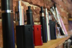 Electronic cigarette on a background of vape shop. E-cigarette for vaping. photo