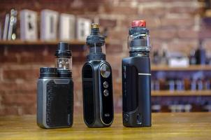 Electronic cigarette on a background of vape shop. E-cigarette for vaping. photo