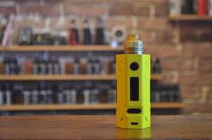 Electronic cigarette on a background of vape shop. E-cigarette for vaping. photo