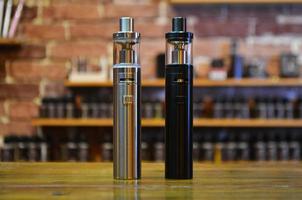 Electronic cigarette on a background of vape shop. E-cigarette for vaping. photo