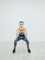 woman in sportswear doing squat photo