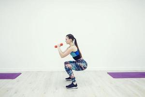 Woman doing squats photo