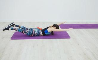 Sporting woman practicing the cobra pose photo