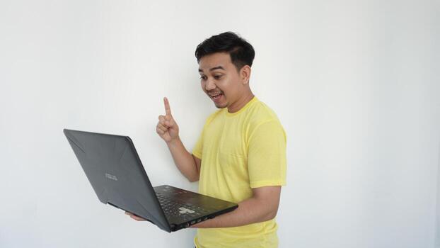 Young man with index finger up with surprised expression photo