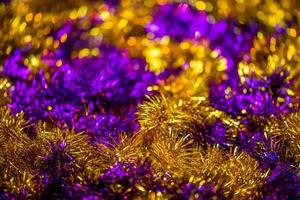 abstract pink and gold tinsel close-up background with bokeh defocus photo