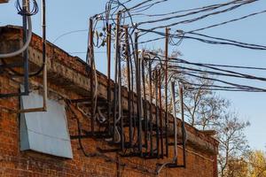 lots of wires sticking out of an old brick electrical substation building photo