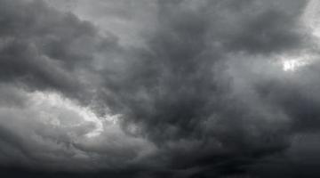 dramatic grey storm clouds background upward view from ground photo