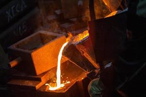 Close-up view of industrial chill casting. The process of for filling out mold with molten metal. photo