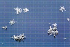 snowflakes on LCD screen of mobile phone macro background photo