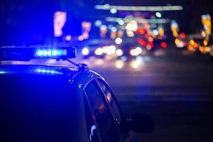 police car lights at night in city with selective focus and bokeh photo