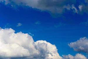 Regular spring clouds on blue sky at daylight in continental europe. Close shot wit telephoto lens and polarizing filter. photo