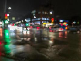 defocused night rain city street cross roads view photo