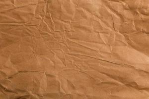 Ragged crumpled brown kraft paper texture and full frame background photo