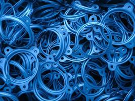 an abstract background of classic blue color coated metal stmped flange ring parts photo